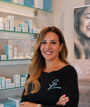 A Woman Standing In Front Of A Store