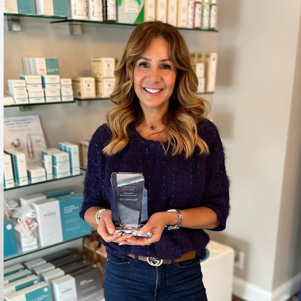 a woman standing in front of a book shelf